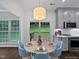 Cozy dining area featuring a round table, stylish chairs, and sliding doors to the backyard deck at 8640 Swarthmore Dr, Raleigh, NC 27615