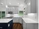 Beautiful kitchen with gray cabinetry, quartz countertops, stainless appliances, and modern lighting fixtures at 8640 Swarthmore Dr, Raleigh, NC 27615