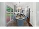 Well-lit kitchen with a view of a deck, featuring an island and stainless steel appliances at 8640 Swarthmore Dr, Raleigh, NC 27615