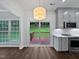 Open kitchen area with a view of the deck, featuring gray cabinets, stainless steel appliances and hardwood floors at 8640 Swarthmore Dr, Raleigh, NC 27615