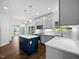Bright kitchen with gray cabinets, stainless appliances, and a center island, filled with natural light at 8640 Swarthmore Dr, Raleigh, NC 27615