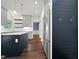 Modern kitchen with stainless steel appliances, gray cabinets, and a dark blue island, plus hardwood floors at 8640 Swarthmore Dr, Raleigh, NC 27615