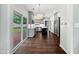 Bright, open kitchen with gray cabinets, an island, stainless steel appliances, and access to an outdoor deck at 8640 Swarthmore Dr, Raleigh, NC 27615