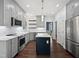 Well-lit kitchen featuring gray cabinets, stainless appliances, and a dark blue island with white countertops at 8640 Swarthmore Dr, Raleigh, NC 27615