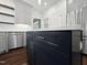 Kitchen featuring gray cabinets, stainless steel appliances, dark blue island, and hardwood flooring at 8640 Swarthmore Dr, Raleigh, NC 27615