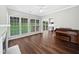 Spacious living room featuring large windows, hardwood floors, and a view of the backyard at 8640 Swarthmore Dr, Raleigh, NC 27615