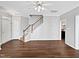 Living room with hardwood floors, staircase, and an open view of the kitchen area at 8640 Swarthmore Dr, Raleigh, NC 27615