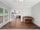 View of a living room, showcasing hardwood floors and access to the kitchen and deck at 8640 Swarthmore Dr, Raleigh, NC 27615