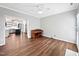 Open-concept living room with hardwood floors, neutral walls, and direct access to the kitchen and hallway at 8640 Swarthmore Dr, Raleigh, NC 27615