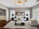 Spacious, virtually staged living room with hardwood floors, contemporary furniture, and decorative wall art at 8640 Swarthmore Dr, Raleigh, NC 27615
