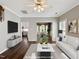 Elegant, virtually staged living room with modern decor, connecting seamlessly to the dining area and kitchen at 8640 Swarthmore Dr, Raleigh, NC 27615