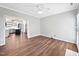 Open living room with wood floors leading into the bright and updated kitchen at 8640 Swarthmore Dr, Raleigh, NC 27615