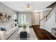 Bright living room featuring hardwood floors, ceiling fan, and staircase to the second floor at 8640 Swarthmore Dr, Raleigh, NC 27615