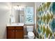 Bathroom featuring a wood vanity, a toilet and a teal and green patterned shower curtain at 8715 Macedonia Lake Dr, Cary, NC 27518