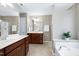 Spacious bathroom with double vanity, soaking tub, glass shower, and neutral color scheme at 8715 Macedonia Lake Dr, Cary, NC 27518