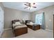 Bedroom with two twin beds, a ceiling fan, and a window that provides natural light at 8715 Macedonia Lake Dr, Cary, NC 27518