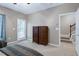 Bedroom features a door to the outside, two dressers, and stairs to another floor at 8715 Macedonia Lake Dr, Cary, NC 27518