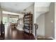 Inviting foyer with hardwood floors, a bookcase, dining area, and staircase at 8715 Macedonia Lake Dr, Cary, NC 27518