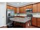 Modern kitchen featuring a central island, granite countertops, and stainless appliances at 8715 Macedonia Lake Dr, Cary, NC 27518