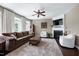 Cozy living room with fireplace, plush seating, and a ceiling fan for comfort at 8715 Macedonia Lake Dr, Cary, NC 27518