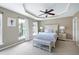 Serene main bedroom with large windows, tray ceiling, and neutral tones at 8715 Macedonia Lake Dr, Cary, NC 27518