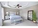 Elegant main bedroom featuring a tray ceiling, large windows, and comfortable furnishings at 8715 Macedonia Lake Dr, Cary, NC 27518