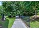 Picturesque walking path framed by lush trees and greenery, offering a serene outdoor experience at 8715 Macedonia Lake Dr, Cary, NC 27518
