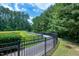 Scenic walking path surrounded by lush greenery and a serene pond, perfect for outdoor enjoyment at 8715 Macedonia Lake Dr, Cary, NC 27518
