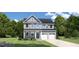 Charming two-story home with blue accents, a well-manicured lawn, and an attached two-car garage at 882 Nichols View Ct, Raleigh, NC 27604
