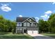 Charming two-story home with a well-manicured lawn, two-car garage, and classic architectural details at 892 Nichols View Ct, Raleigh, NC 27604