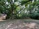 View of the wooded backyard and an outbuilding, showcasing the property's natural surroundings at 94 Bynum Church Rd, Pittsboro, NC 27312