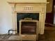Indoor shot of an ornate, non-working fireplace with a heater in front at 94 Bynum Church Rd, Pittsboro, NC 27312