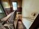 Interior shot showcasing the detailed woodwork of the staircase and landing with natural light from the window at 94 Bynum Church Rd, Pittsboro, NC 27312
