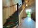 The stairway is painted green and lit by a vintage chandelier leading into an open doorway at 94 Bynum Church Rd, Pittsboro, NC 27312