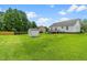 A lush, well-maintained backyard enhances the appeal of this property at 99 Winwood Dr, Angier, NC 27501