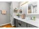 A tidy bathroom featuring dual sinks, grey vanity, and updated fixtures at 99 Winwood Dr, Angier, NC 27501