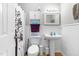 A bright bathroom featuring a pedestal sink and neutral finishes at 99 Winwood Dr, Angier, NC 27501