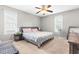 A cozy bedroom with a ceiling fan, neutral walls, and a large bed at 99 Winwood Dr, Angier, NC 27501