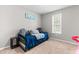 A bedroom with blue bedspread, area rug, and natural light at 99 Winwood Dr, Angier, NC 27501
