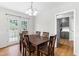 Bright dining room with hardwood floors, elegant chandelier, and access to the backyard at 99 Winwood Dr, Angier, NC 27501