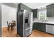 Modern kitchen featuring stainless steel appliances, dark green cabinetry, and hardwood floors at 99 Winwood Dr, Angier, NC 27501