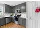 A lovely kitchen featuring gray cabinets, stainless steel appliances, and wood flooring at 99 Winwood Dr, Angier, NC 27501