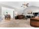Open concept living room leading to dining area, featuring vaulted ceiling and comfortable furnishings at 99 Winwood Dr, Angier, NC 27501