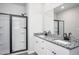Modern bathroom with a double-sink vanity with granite countertop and a glass-enclosed shower at 1004 Rhino Bnd, Oxford, NC 27565