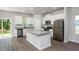 Modern kitchen with stainless steel appliances, an island, white cabinets, and laminate flooring at 1004 Rhino Bnd, Oxford, NC 27565