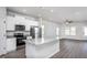 Open-concept kitchen and living room with granite countertops and stainless steel appliances at 1004 Rhino Bnd, Oxford, NC 27565
