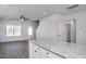 Open-concept kitchen and living room with a granite-topped island and laminate flooring at 1004 Rhino Bnd, Oxford, NC 27565