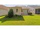 Backyard featuring manicured lawn with a patio connected to the beige siding of the house at 1019 Santiago St, Durham, NC 27703