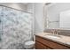 Bright bathroom with granite countertop, decorative shower curtain, and white toilet at 1019 Santiago St, Durham, NC 27703