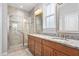 Elegant bathroom featuring a dual sink vanity, large mirror, and glass enclosed shower at 1019 Santiago St, Durham, NC 27703